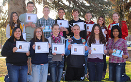 SUCCESS students, each holding several award certificates