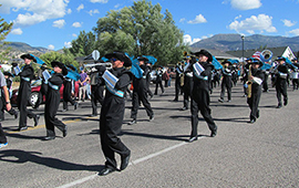 SUCCESS students in the Canyon View Marching Band march down the street.